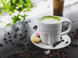 close up photo of matcha latte on a ceramic cup